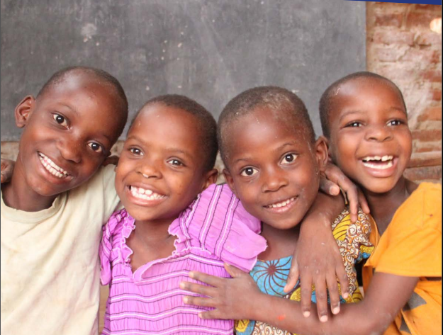 Four children smiling, Uganda, UNICEF